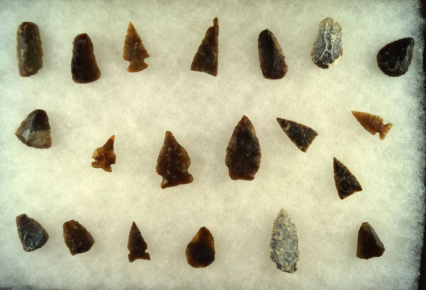 Group of assorted arrowheads and scrapers found in the Dakotas, largest is 1 5/8".