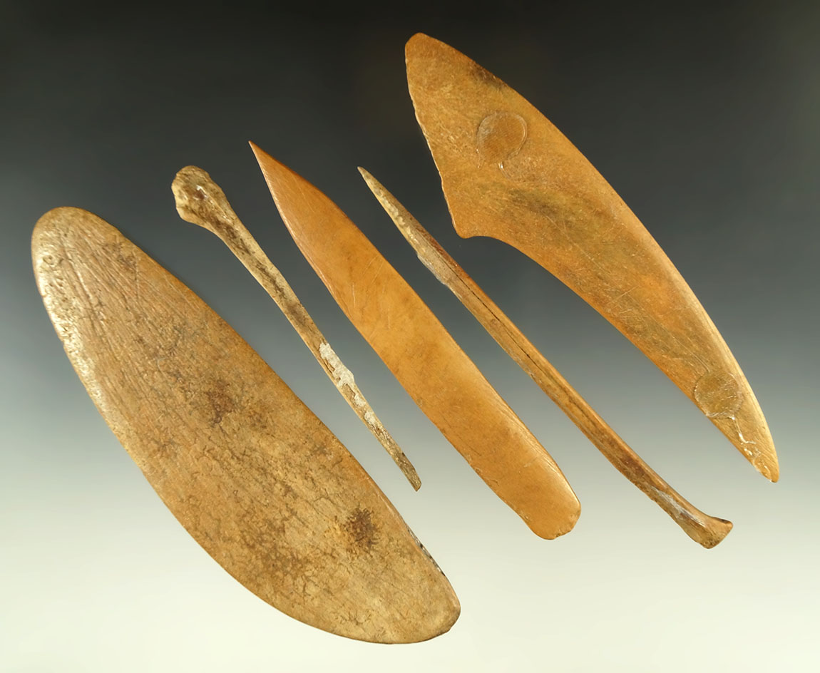 Set of five bone artifacts found in the Dakotas including awls and "squash" knives.