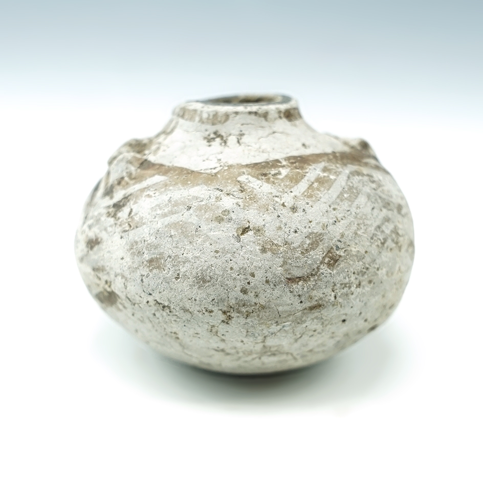 1 3/4" Miniature Anasazi pottery bottle that was anciently salvaged into a jar. Found in New Mexico.