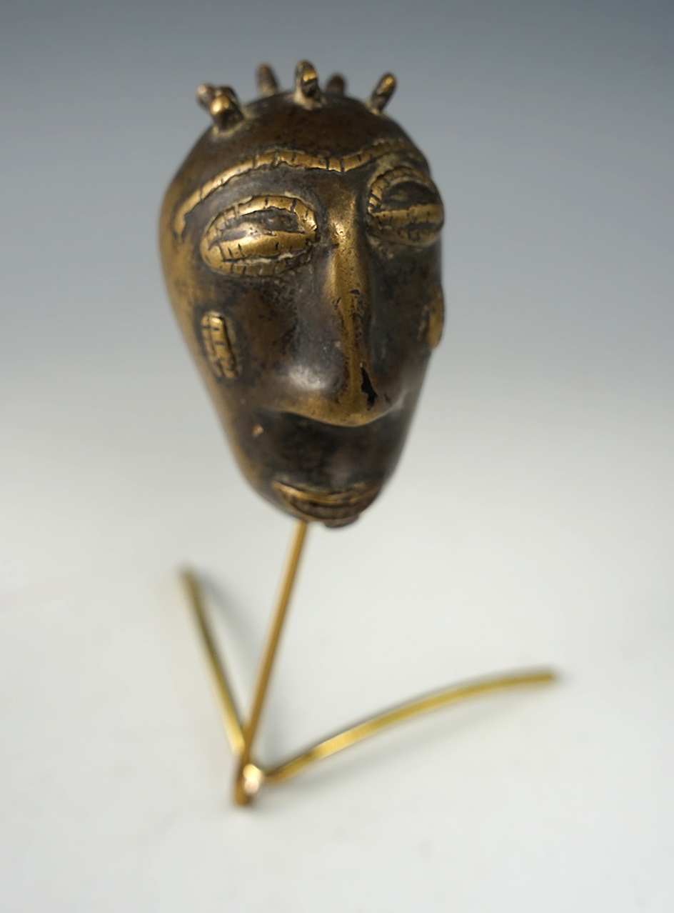 Very old African gold weight made from brass with stand. Weight measures 2 3/4" tall.
