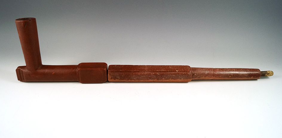 Catlinite Pipe with a two piece stem that is 18" long. Broken and glued in 3 places. Ex. Hastings.