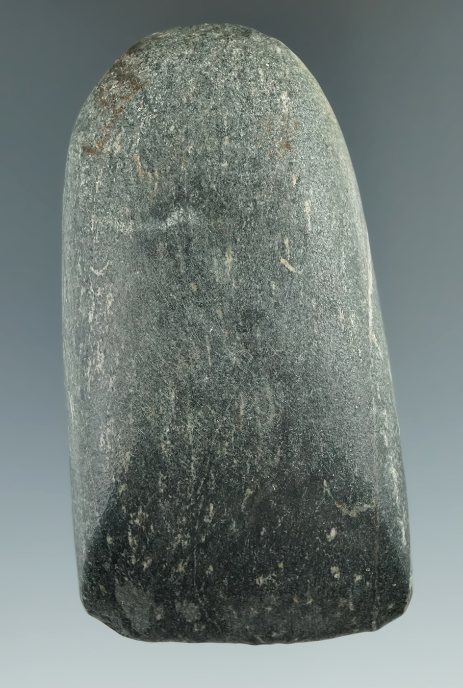 3 5/8" hardstone Celt with excellent use wear to the bit area found in Michigan.