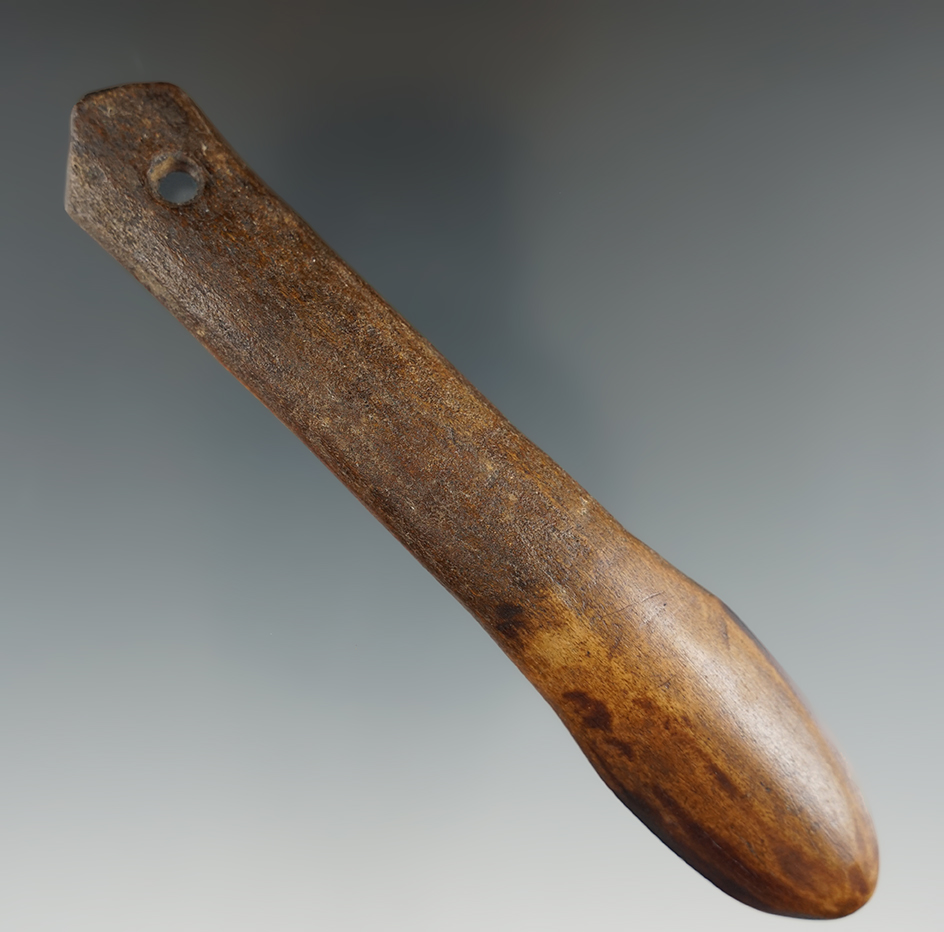 5 1/4" bone spoon that is very nicely made with a suspension hole. Ex. Jim Hogue collection.