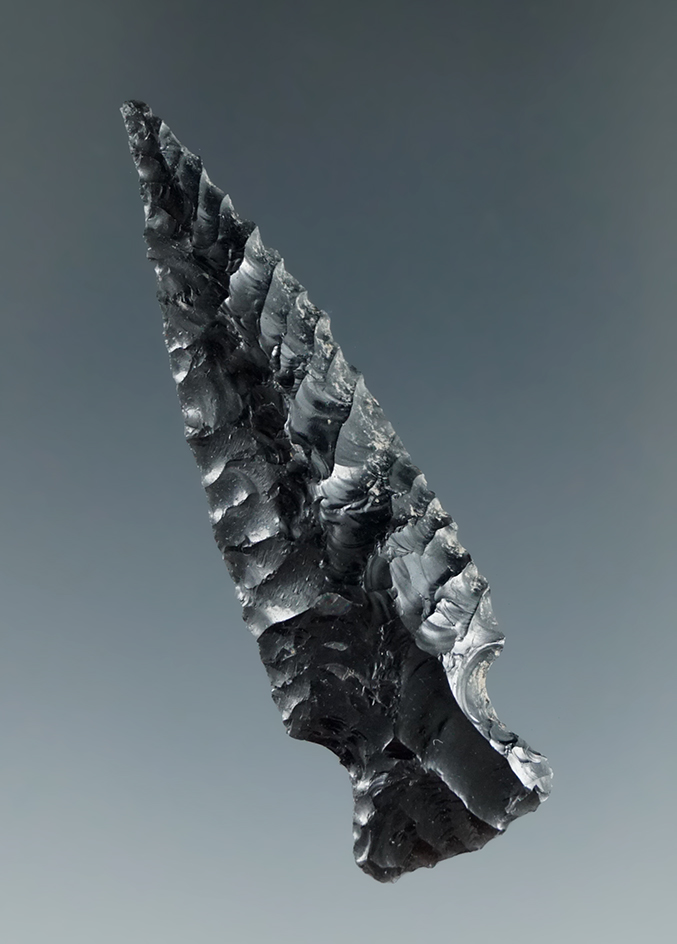 Beautiful parallel oblique ribbon flaking on this 2 3/16" obsidian stemmed point found in Utah.