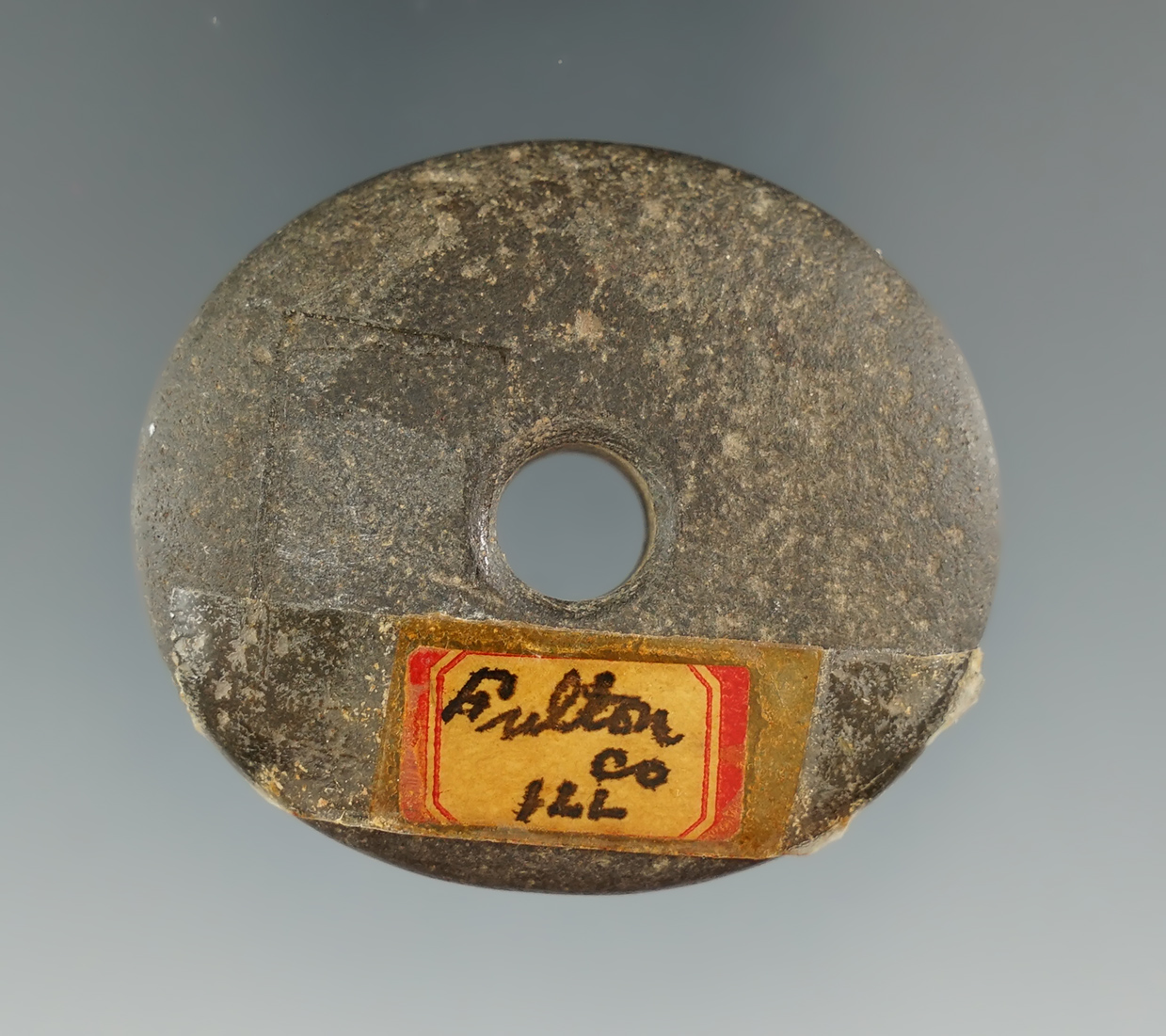 1 7/8" drilled hardstone bead found in Fulton County Illinois. Ex. Henry English collection.