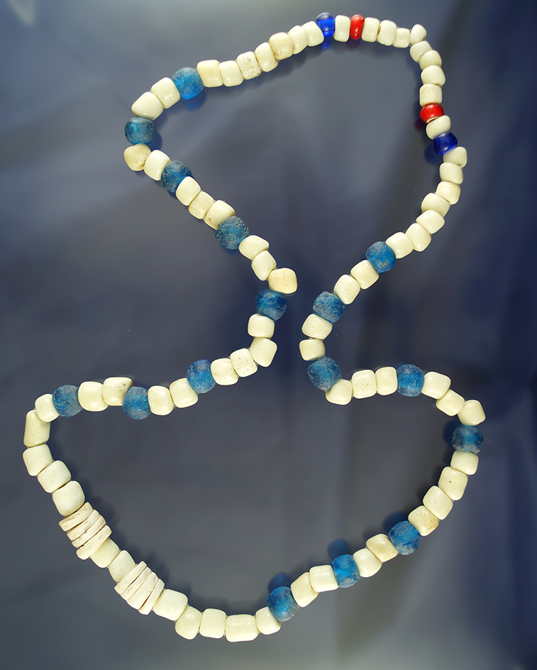 28" long strand of old blue-and-white trade beads and some drilled shell beads.