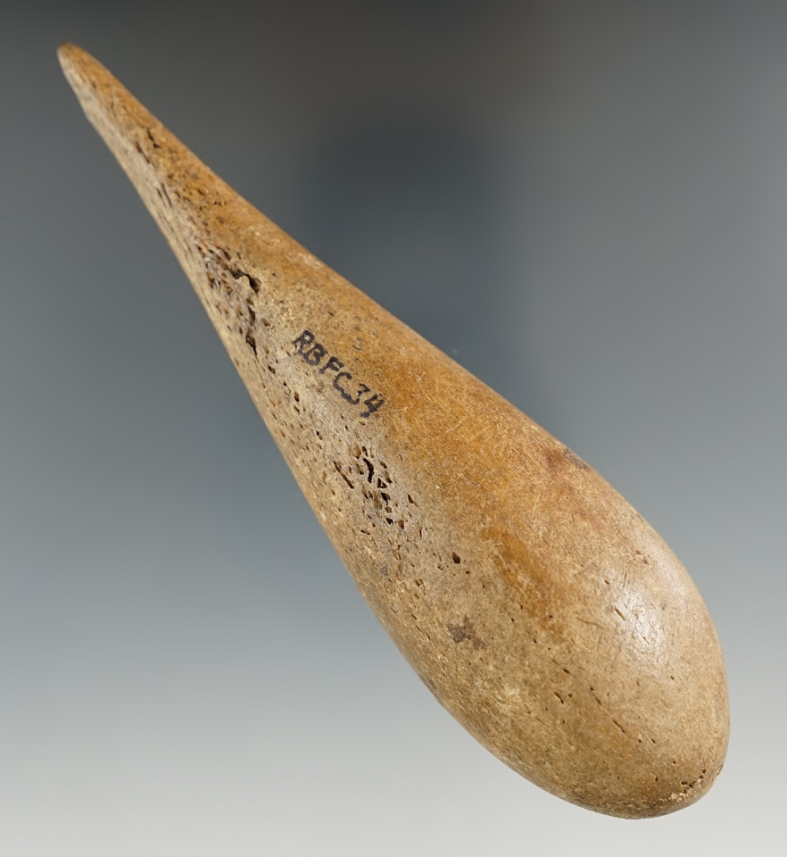 Well styled 5 1/16" Inuit fishing line and sinker with perforation at top and bottom.  Alaska.
