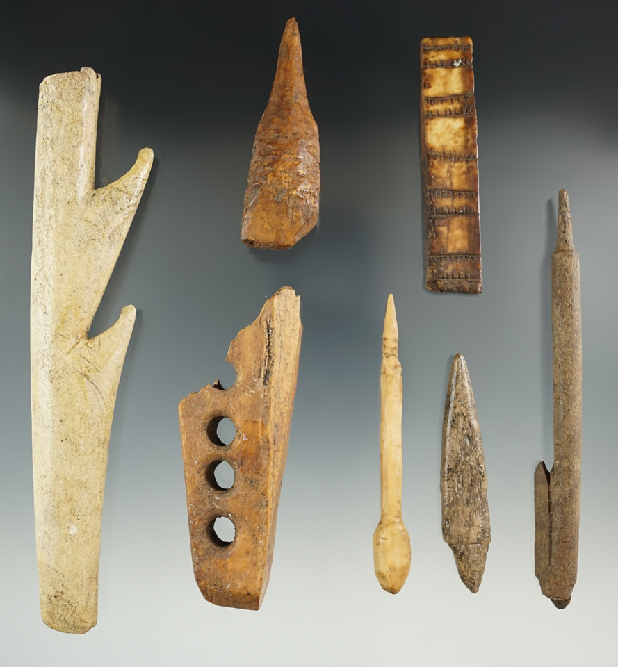 Set of seven assorted bone and ivory artifacts found in Alaska, largest is 6".