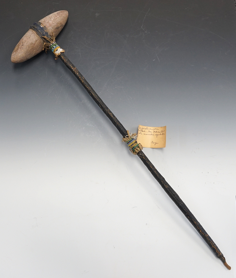 Large Plains Indian War Club. Biconical club head is 9" wide with a 31" leather wrapped handle.