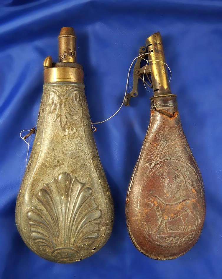 Pair of old powder flasks, 1 is tin and 1 is leather.