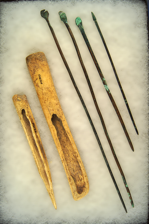 Frame of 6 artifacts from ancient Peru; 4 copper pins and two bone tools. Largest is 11 1/4".