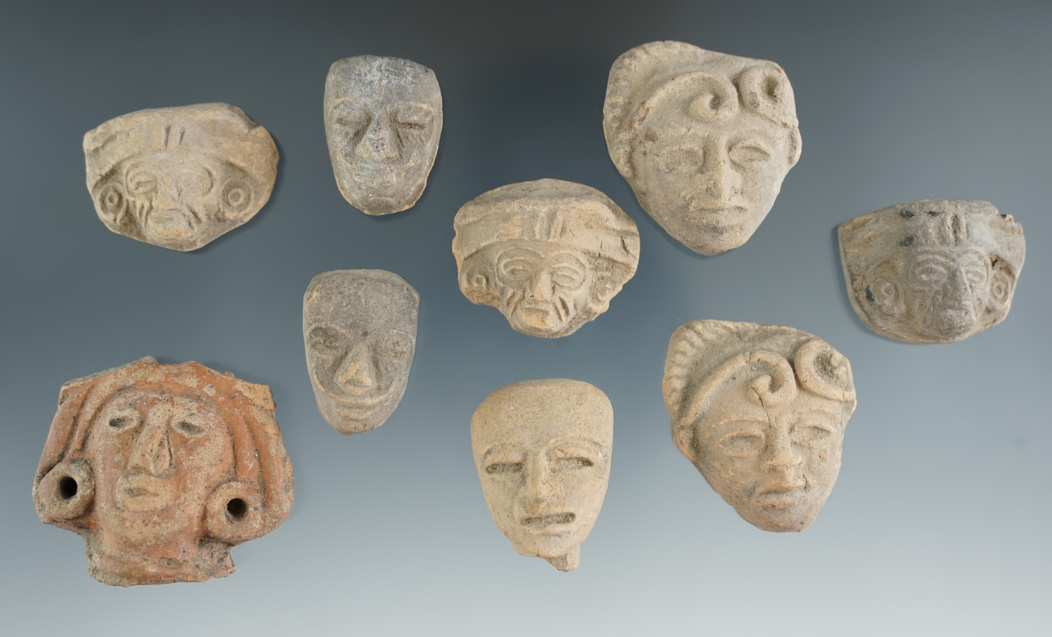 Set of nine pre-Columbian pottery heads found in Mexico. Largest is 1 5/8".