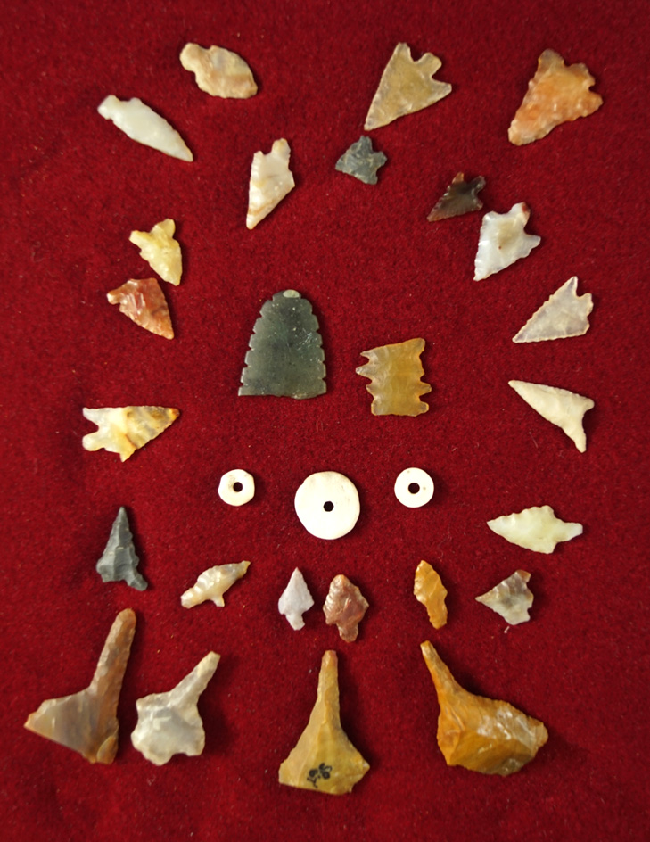 Nice group of many different example of flaked artifacts including two eccentrics and three beads.