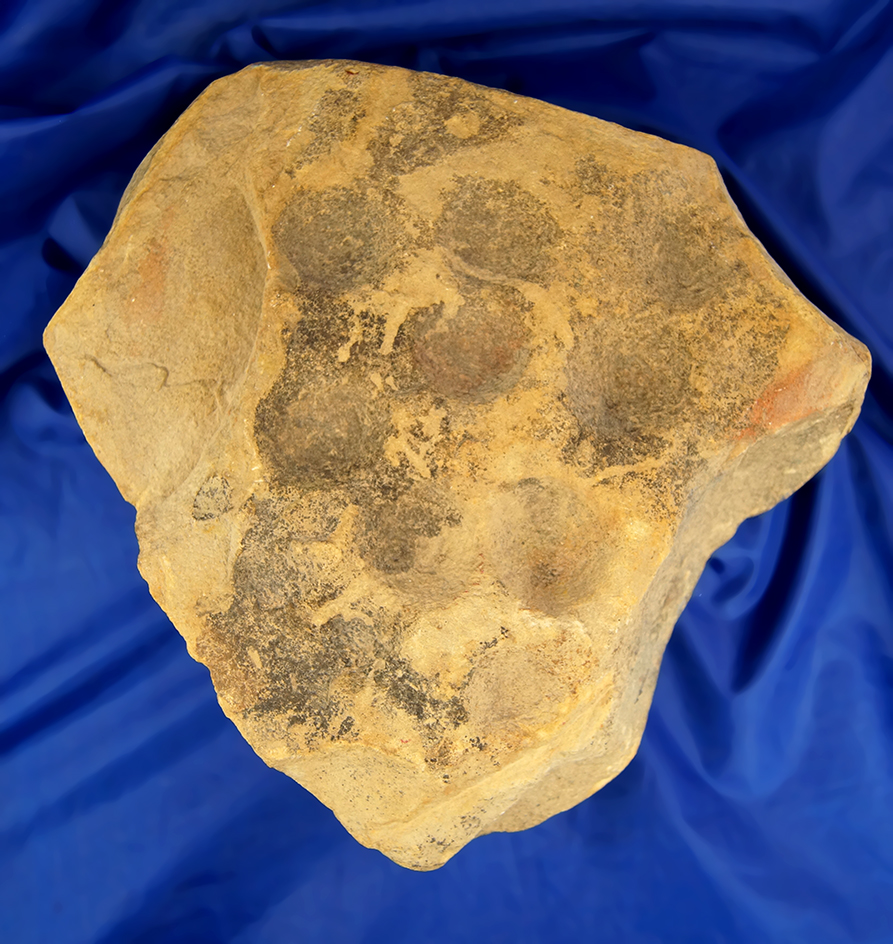 9 1/2" Long sandstone cupstone with 11 divots on one side and 8 divots on reverse.