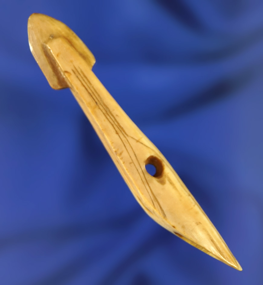 Unique and rare! This 2 11/16 inch long bone carving depicts a harpoon toggle made for an Inuit chil