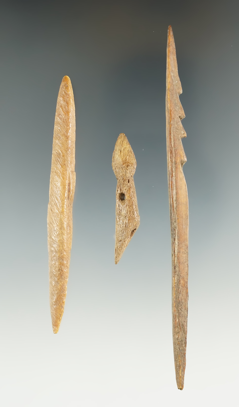 Set of three bone harpoon tips, largest is 4 5/8". Ex. Jim Hogue Collection.