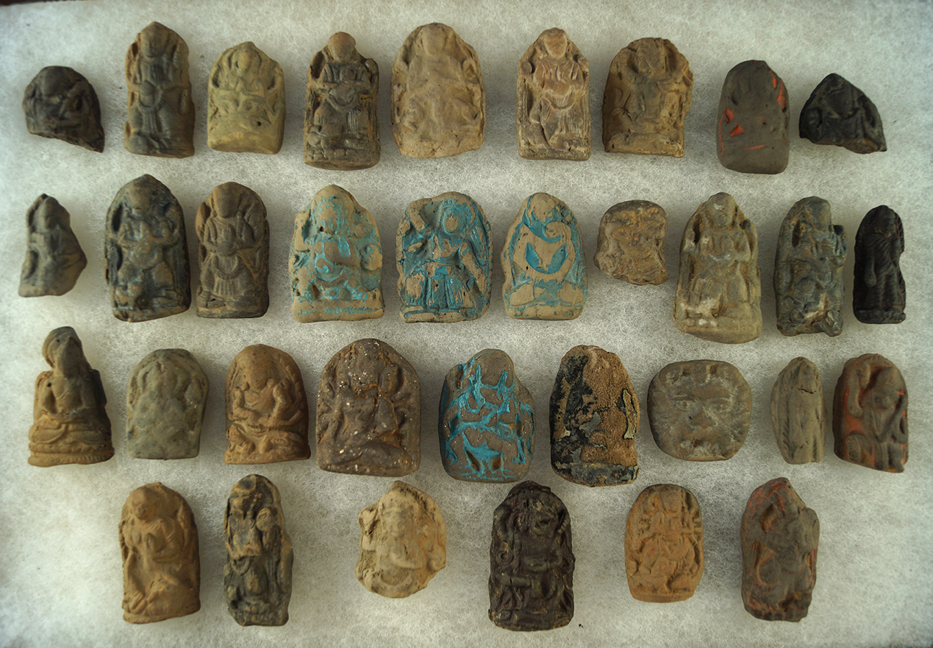 Large group of approximately 34 Buddhist images made from clay recovered in Tibet.