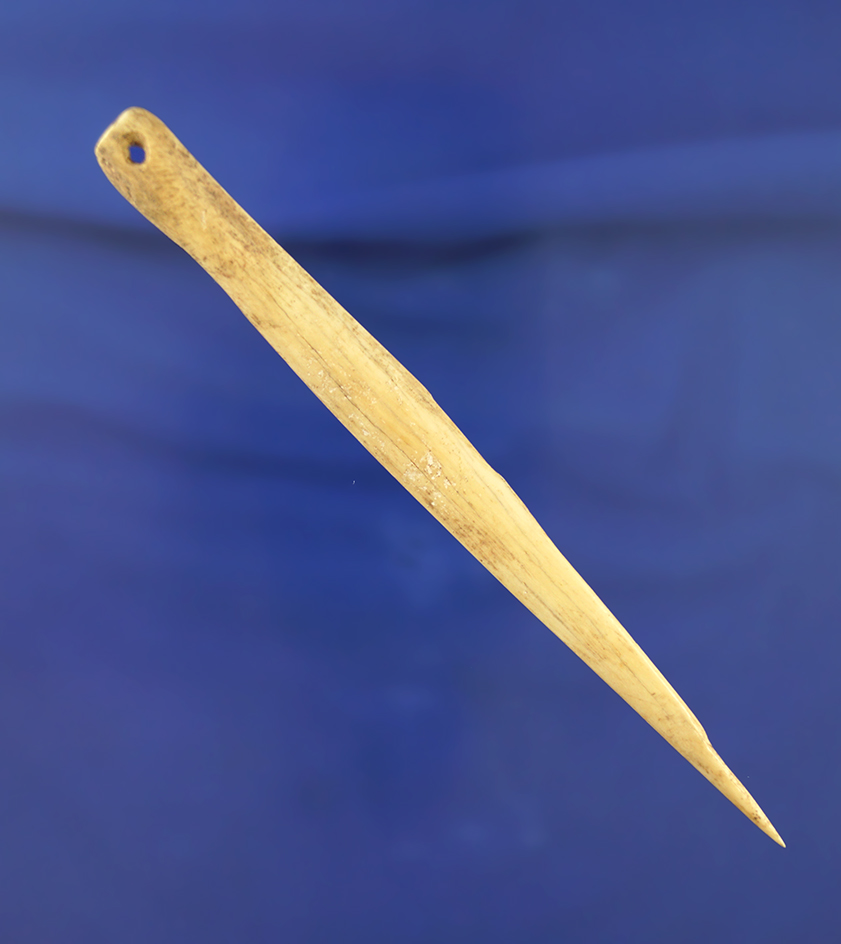 5 3/16" drilled bone needle that is nicely polished found in Kentucky.