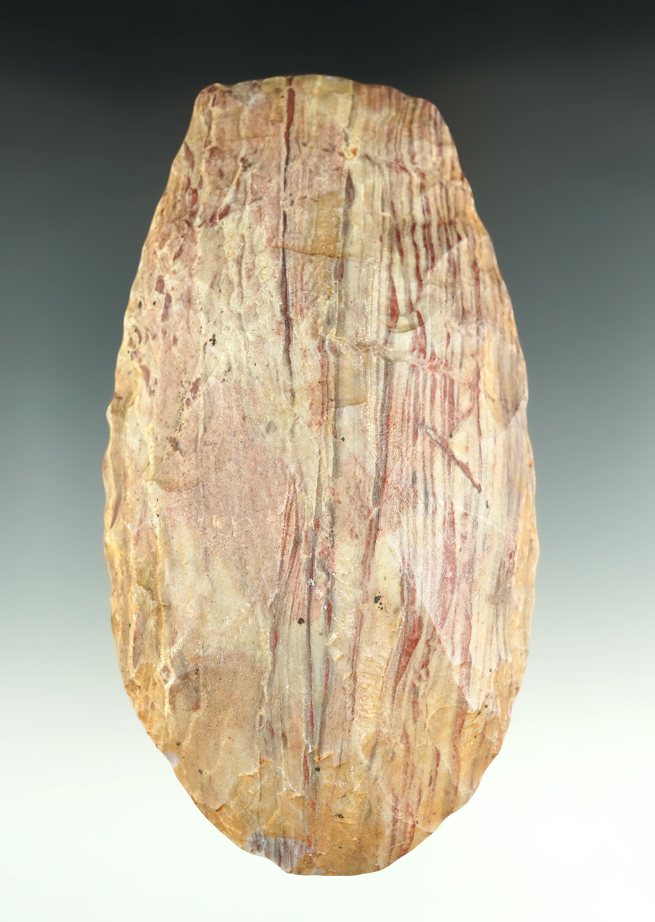 Beautiful striped material on this 5 9/16" Neolithic Flint Celt found in the northern Sahara Desert
