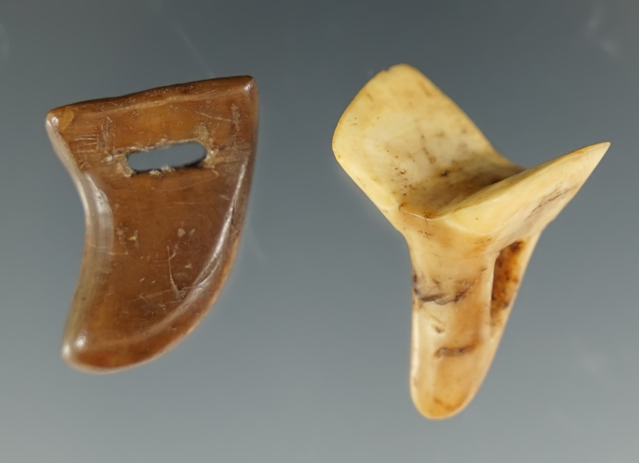 Well styled pair of ivory harpoon finger grips, largest is 1 1/16". Recovered in Alaska.