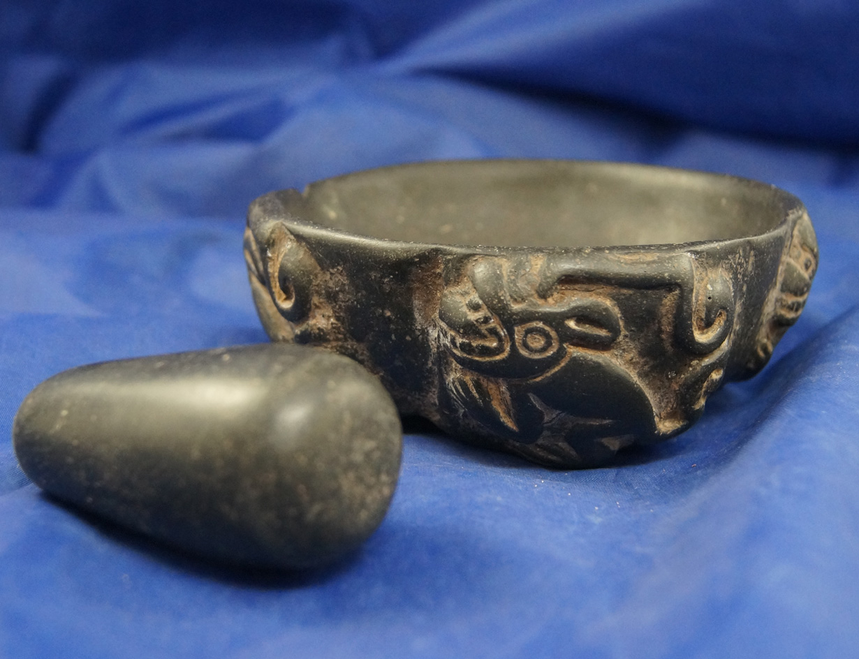 Beautiful 4 1/2" diameter black stone mortar set which has monkeys carved in the bowl exterior Peru.