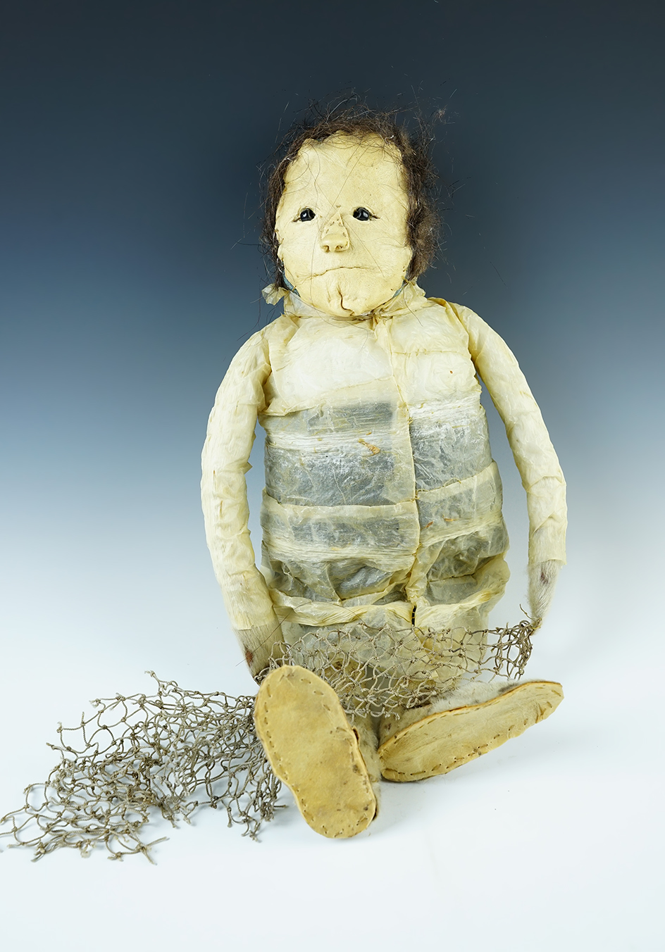 Large 16" tall Inuit doll from Alaska made with seal fur and skin depicting a fisherman with net.