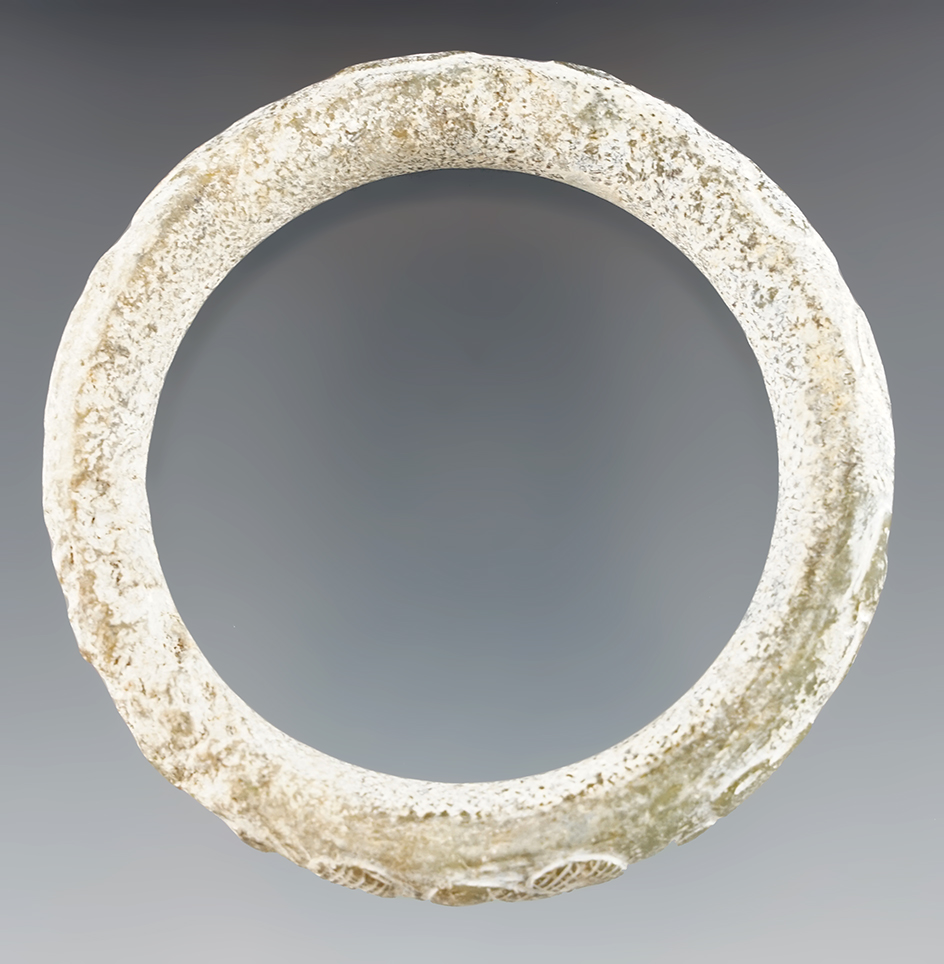 Heavily patinated 3 1/2" nephrite green bracelet with multiple effigies found in Burma.