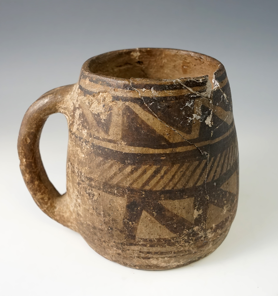 4" tall Anasazi black and white pottery mug from New Mexico with multiple pieces reattached