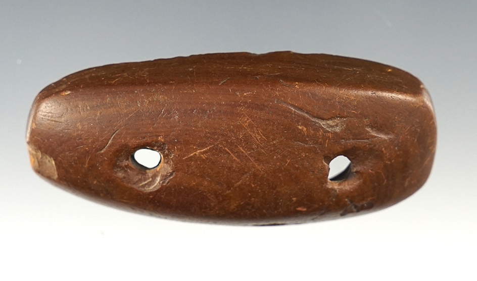 Deeply scooped 2 5/8" Gorget made from patinated Claystone. Found in Tennessee.