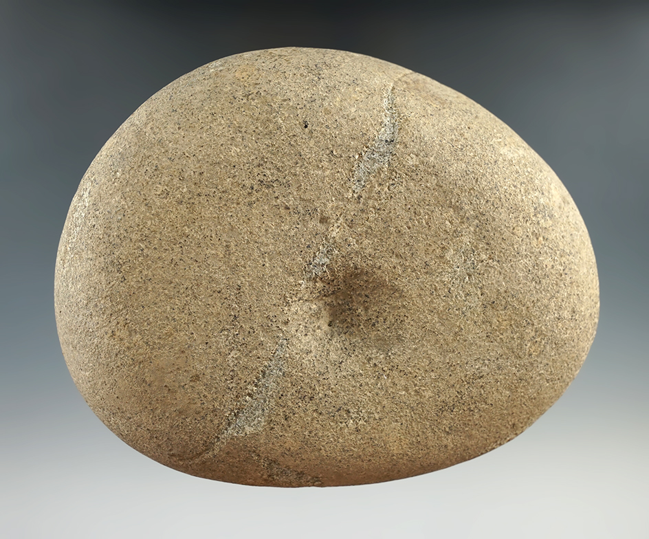 5 1/8" nutting stone with a divot on each side found in Ohio.