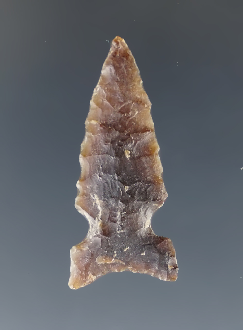 1 1/4" nicely patinated Sidenotch arrow point found in North Dakota.