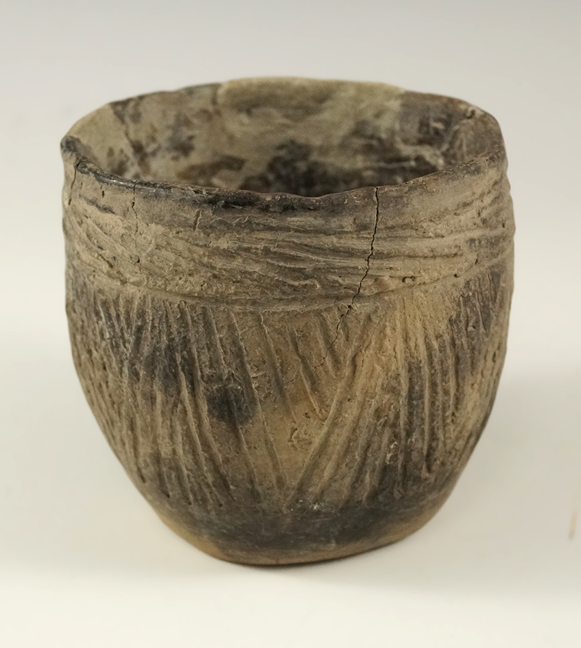 2 3/4" tall by 2 7/8" wide nicely decorated pottery cup with a couple glued back pieces in some rest