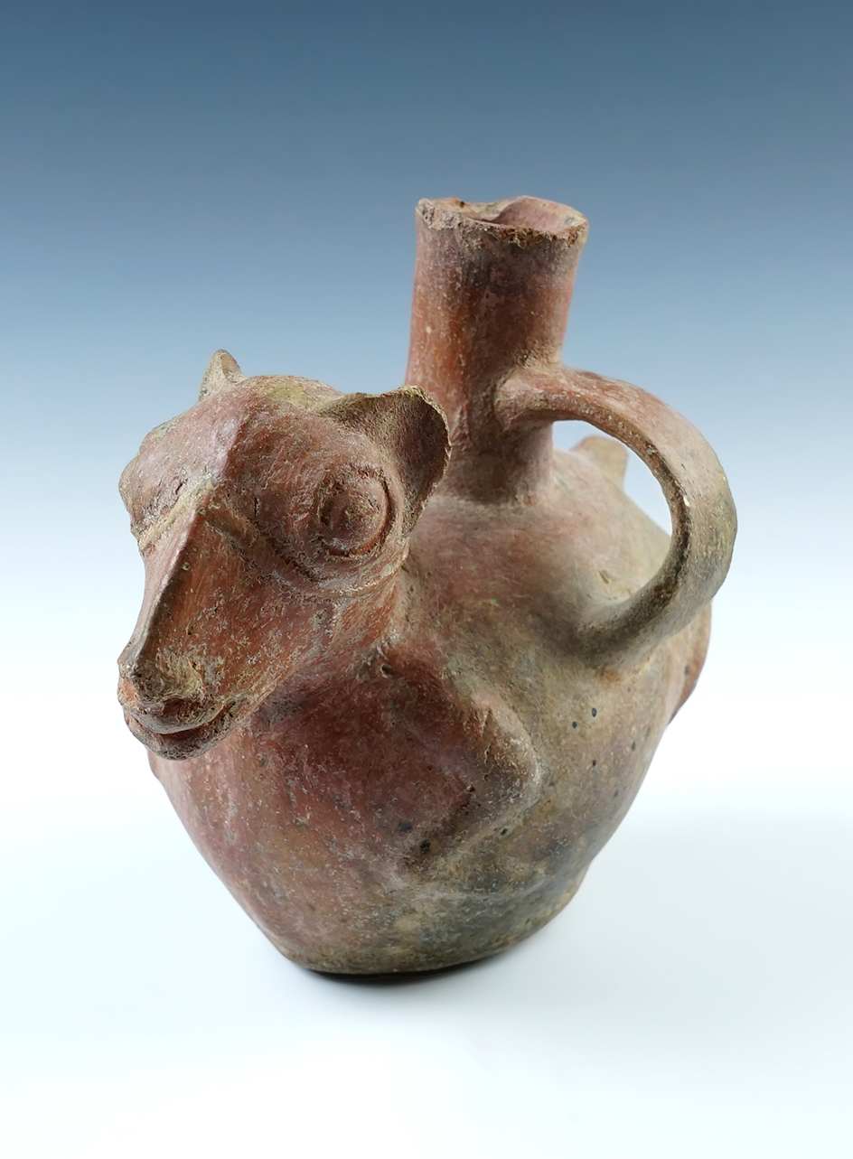 Unique 8 1/4" wide x 6 1/2" tall effigy bottle with a unique side strap recovered in Ecuador. 