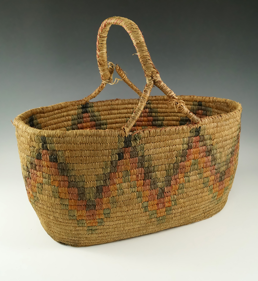 12" wide by 7 1/4" tall handled basket made from green gold and red grass with a wire rim.