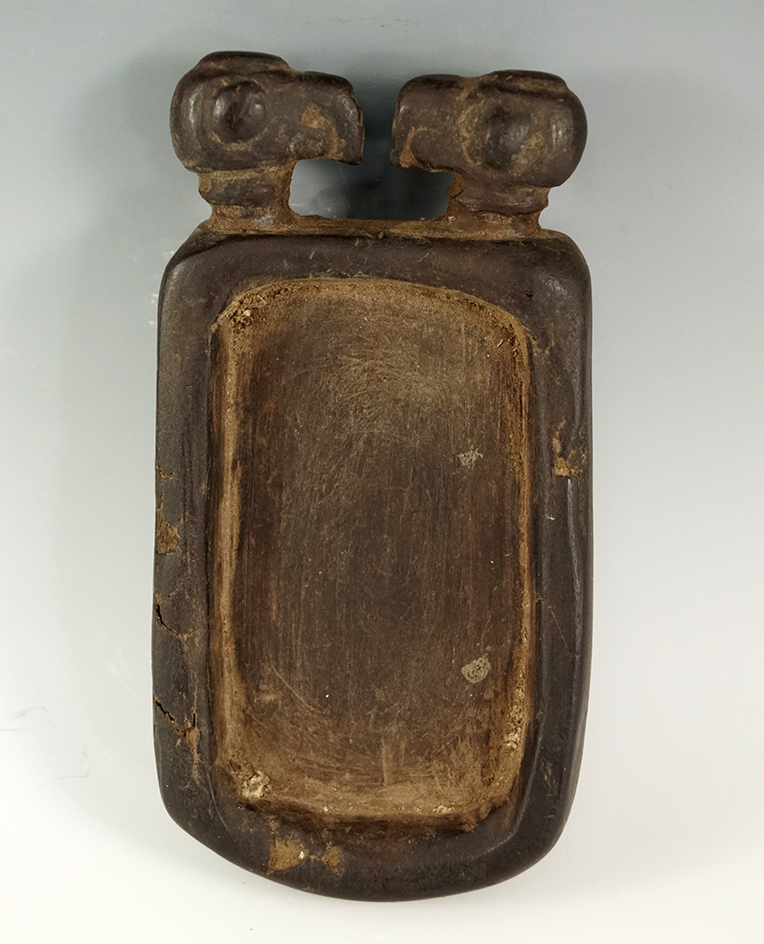 Very unique 5 5/8" wooden pallet with two condor heads carved on one end. Recovered in Peru.