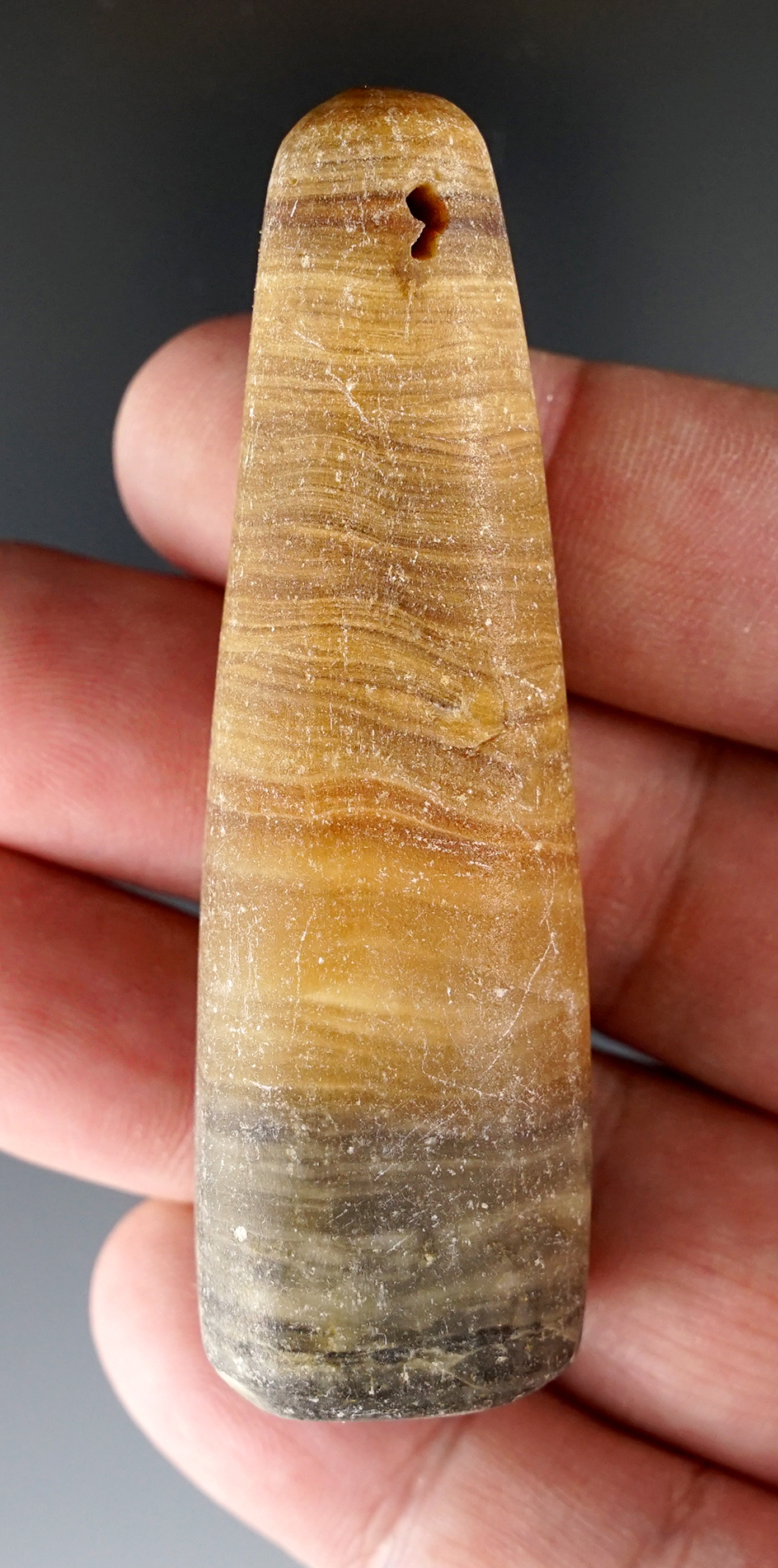 2 15/16" beautiful drilled pendant made from nicely banded travertine stone found in New Mexico.