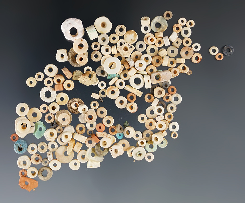 Group of mixed small drilled stone and shell beads found in New Mexico.
