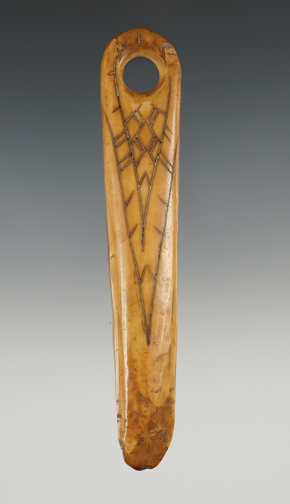 Nicely decorated 5" drilled ivory artifact with incised line design found in Alaska.