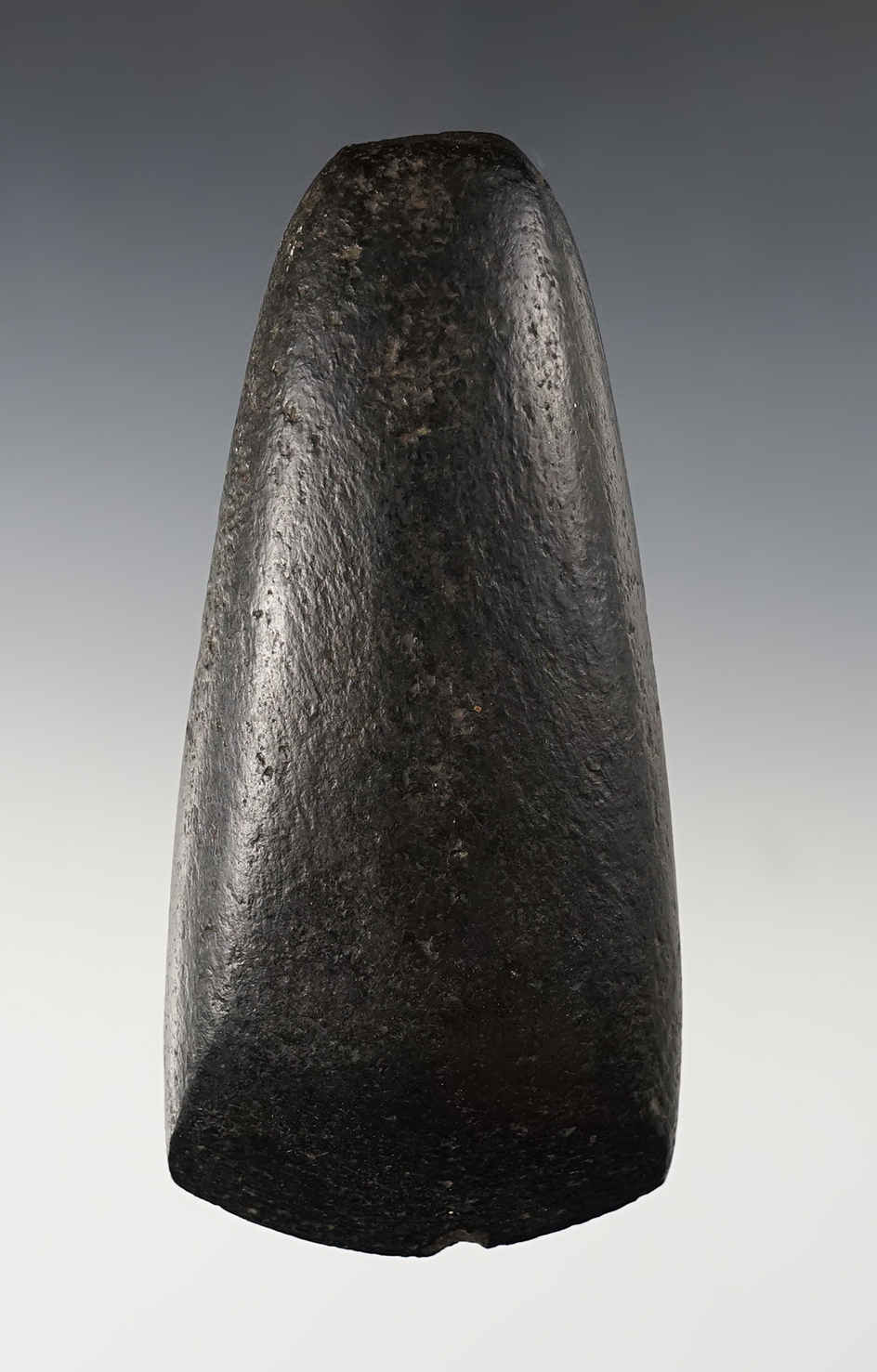 Exceptional 4 3/4" celt made from patinated black stone. Found in the Midwestern U.S. 