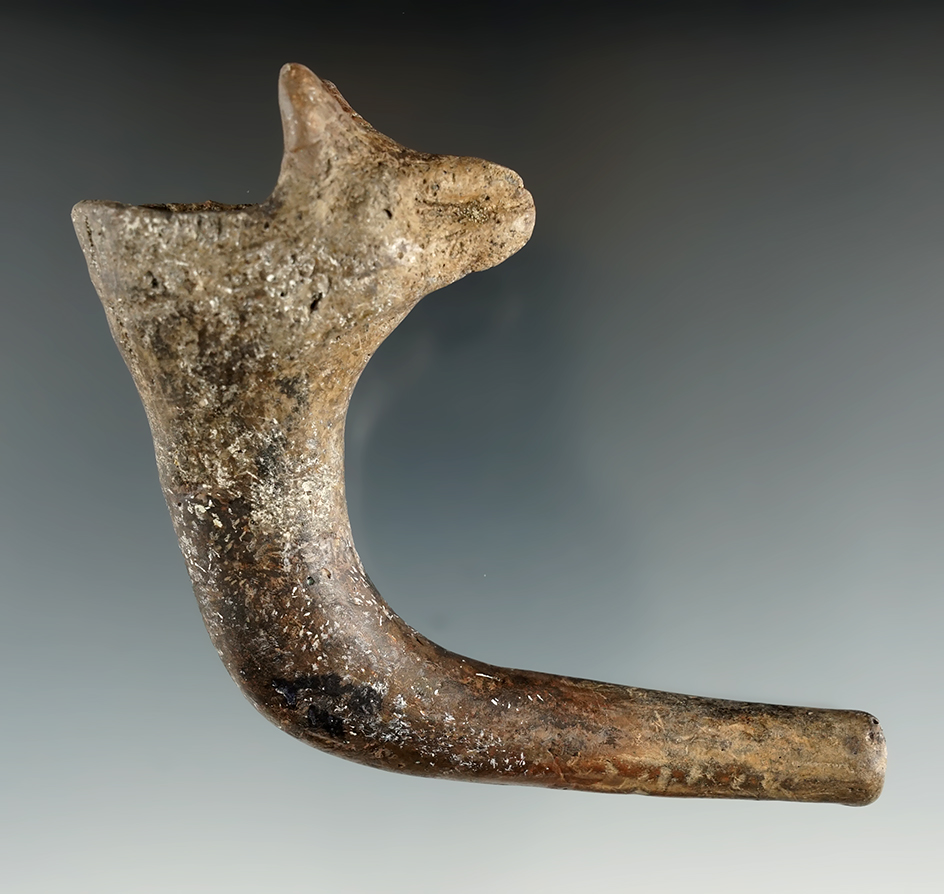 3 1/2" long zoomorphic wolf effigy pipe with a broken and mended elbow and restoration to  ears.