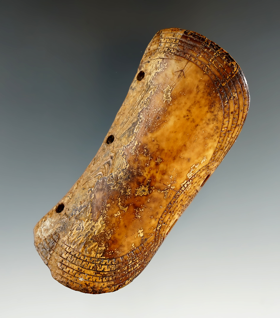 Beautifully decorated old 3 13/16" Inuit bow arm band/risk guard. Nice incised line designs. Alaska.