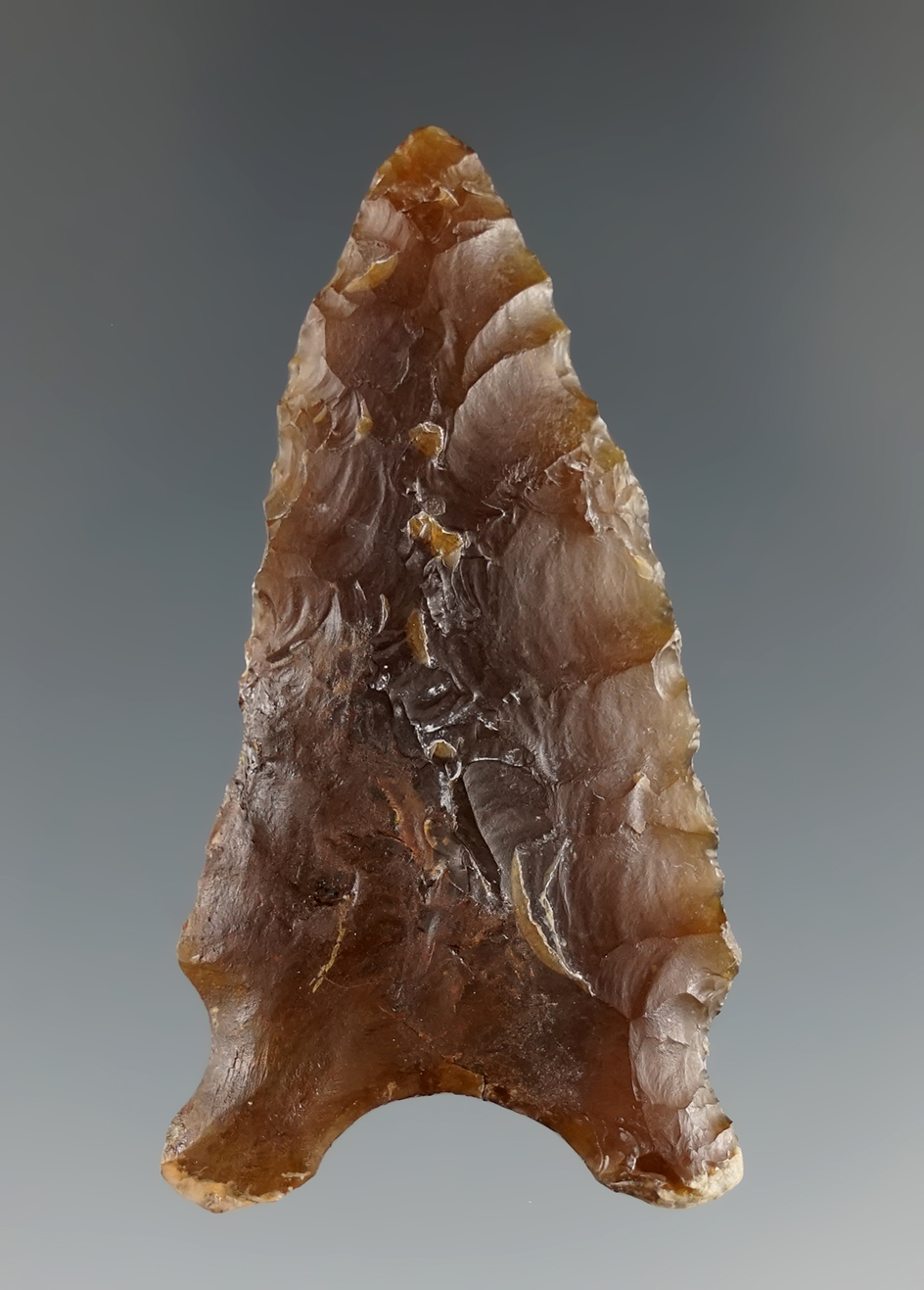 2 1/4" Knife River Flint Dalton variant with restoration to one lobe and lower part of edge. SD.