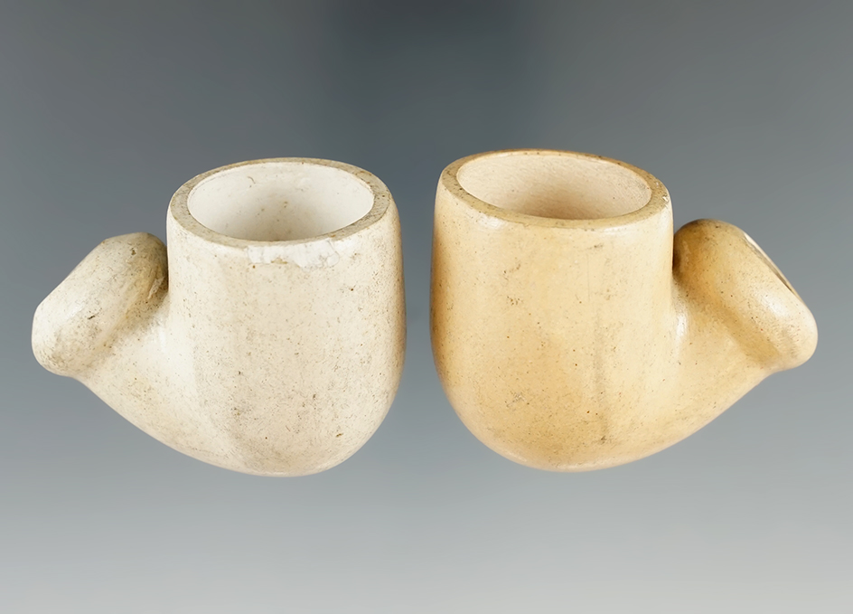 Two of seven clay pipes found in a cellar of an old tavern demolished in Charles Co., Maryland.