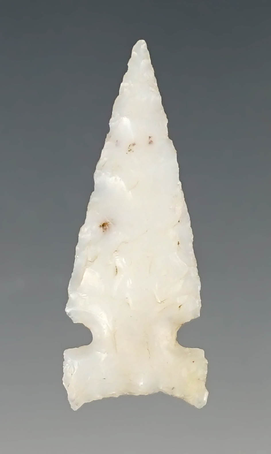 1 1/4" Sidenotch arrow point made from attractive white chalcedony. Found in New Mexico.