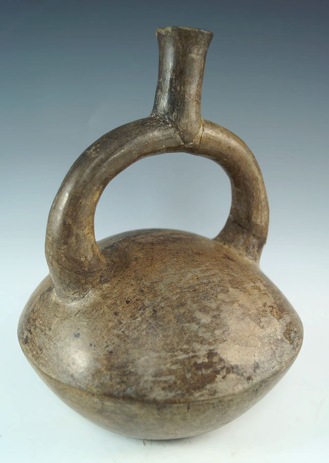 8" tall Pre-Columbian stirrup bottle from Peru. One side of handle is broken and glued.