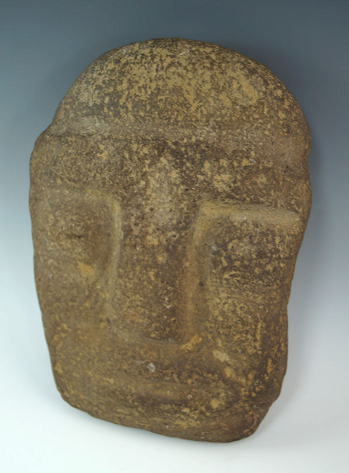 Carved stone face that measures 7" by 5 1/8" from the formative Mayan. Circa 1000 BC.