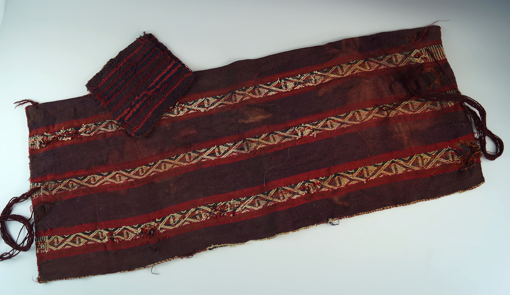 Pair of Peruvian textiles, including a cocoa bag and sash. Ex. Jeff Sadofsky collection.