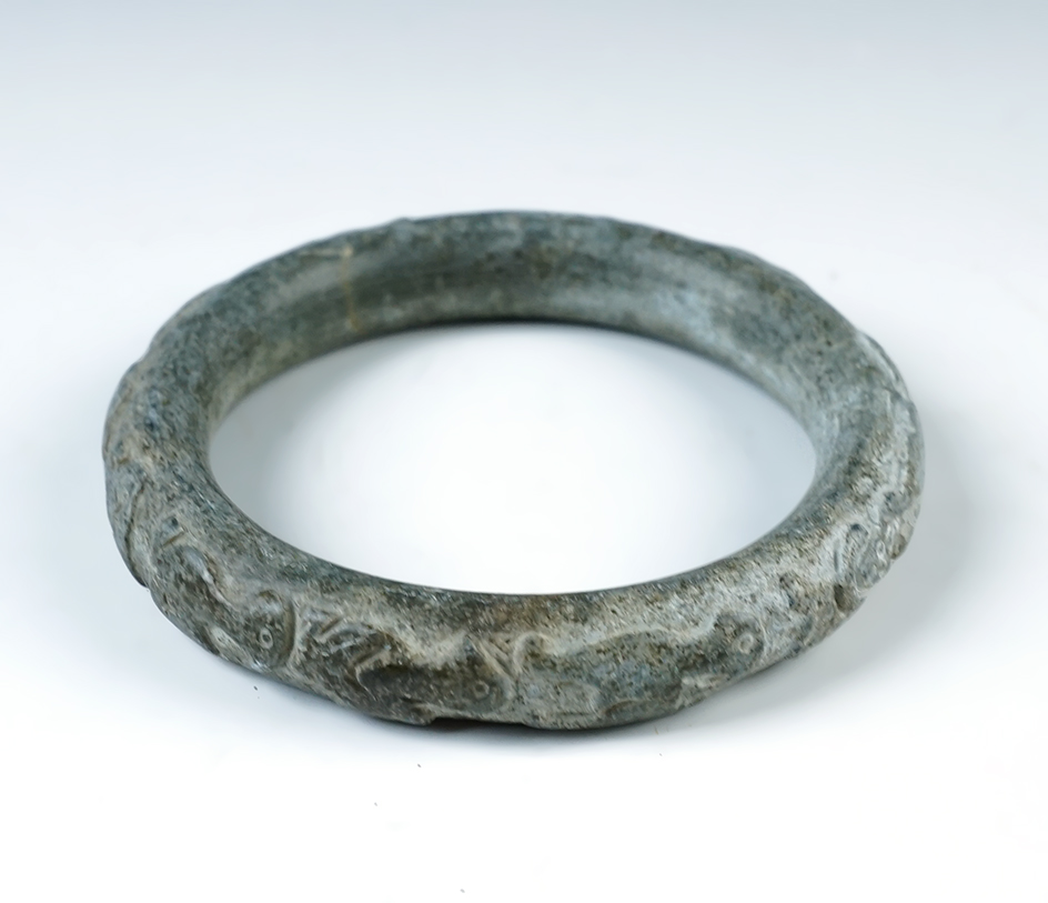 Highly decorated 3 3/8" diameter Jade Bracelet recovered in Burma. Ex. Harry Bogan. 