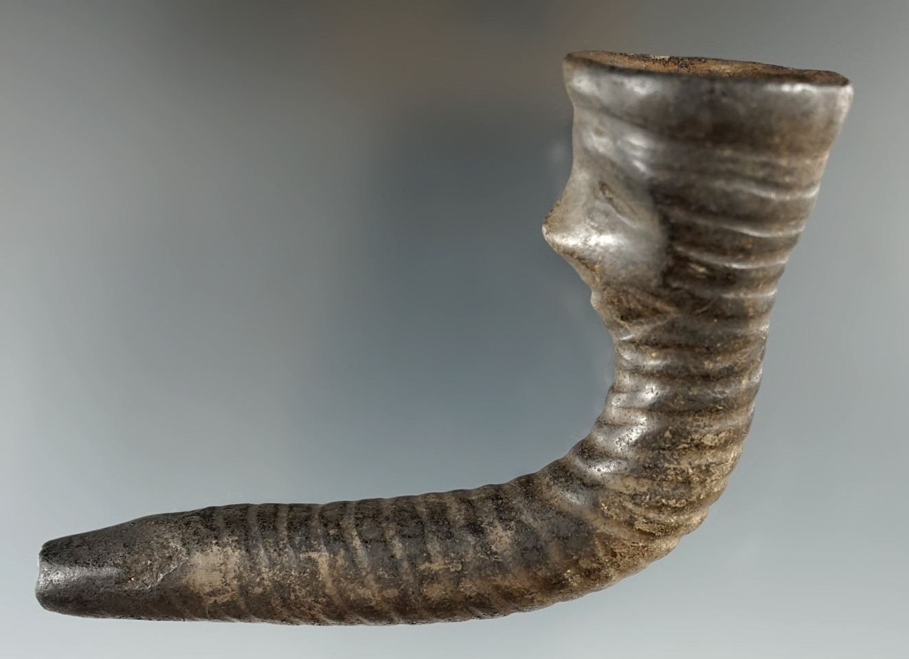 4 1/4" human effigy Iroquois clay pipe with restoration to part of the stem and mouthpiece.