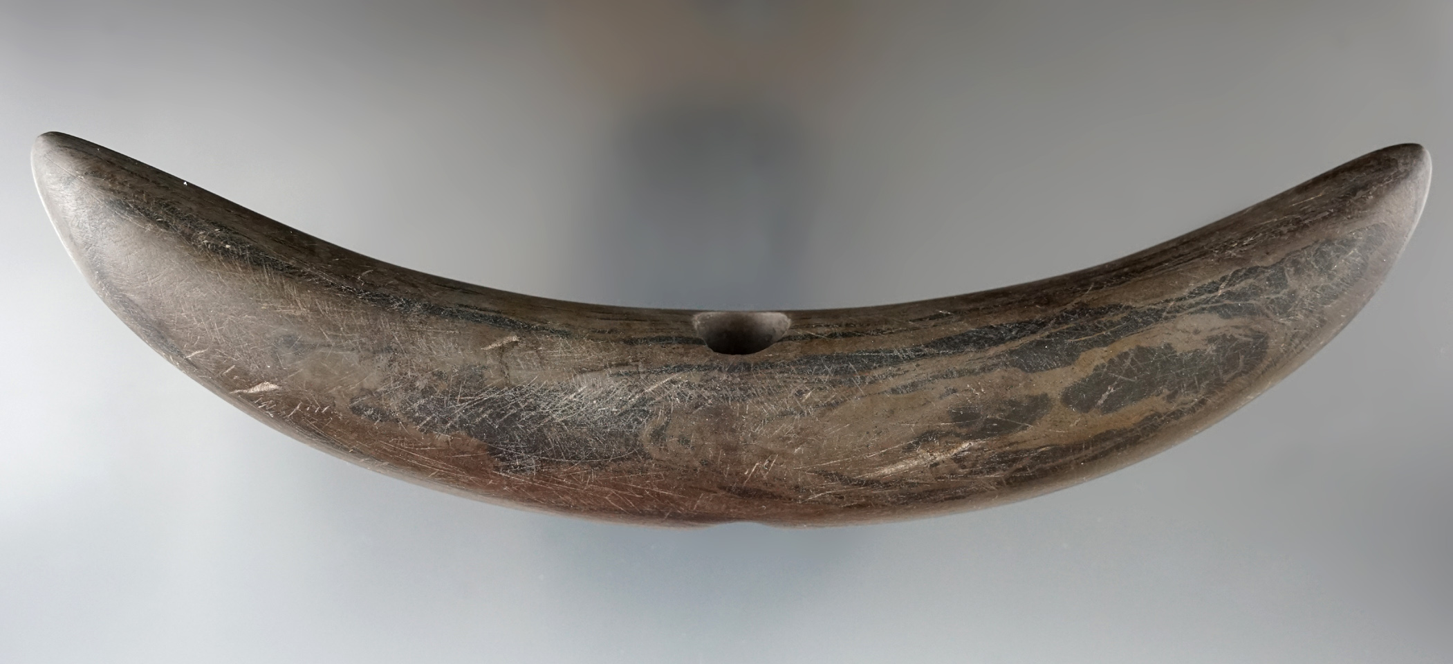 6 13/16" Crescent Bannerstone made from deeply patinated banded slate found in Ohio.